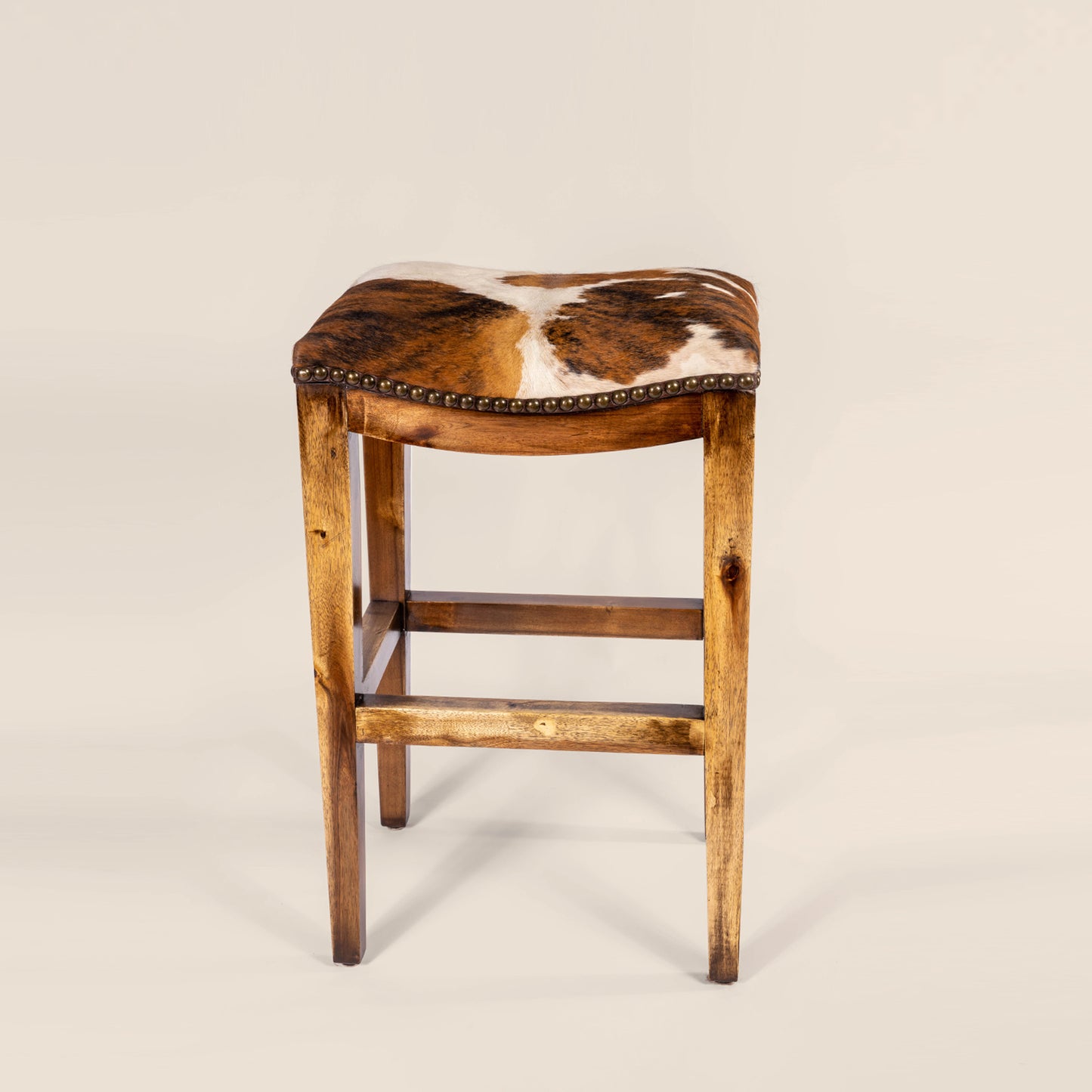 Platzer Saddle Stool in white and brown cowhide leather – front view